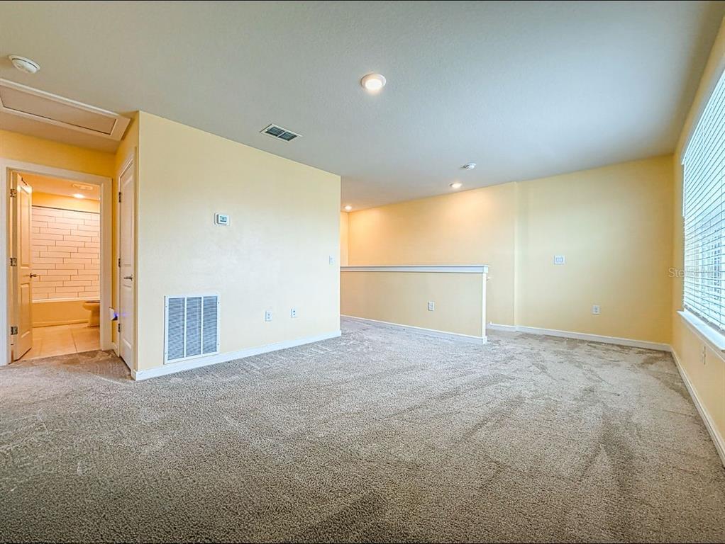 9324 Rally Spring Loop Wesley Chapel, FL 33545 - Photo 18 of 57 a view of an empty room with a window