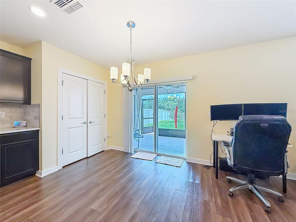 9324 Rally Spring Loop Wesley Chapel, FL 33545 - Photo 19 of 57 a view of a livingroom with wooden floor and chandelier