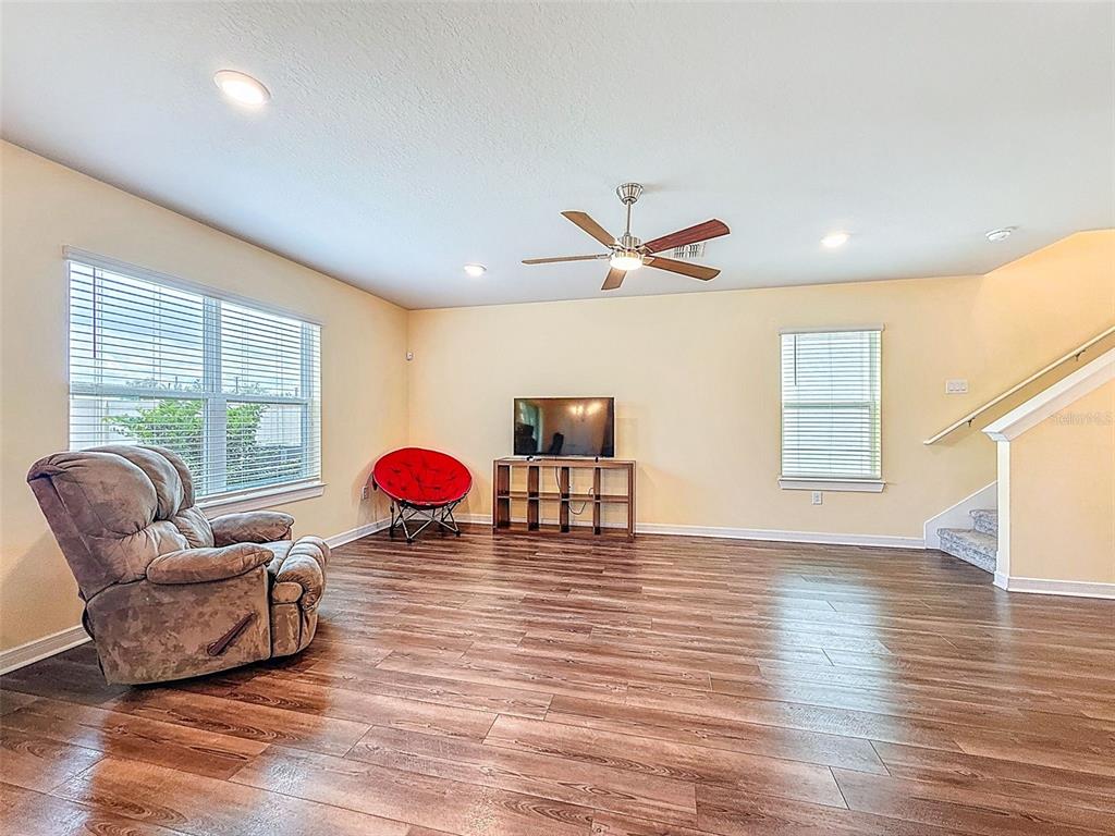 9324 Rally Spring Loop Wesley Chapel, FL 33545 - Photo 22 of 57 a living room with furniture and a large window