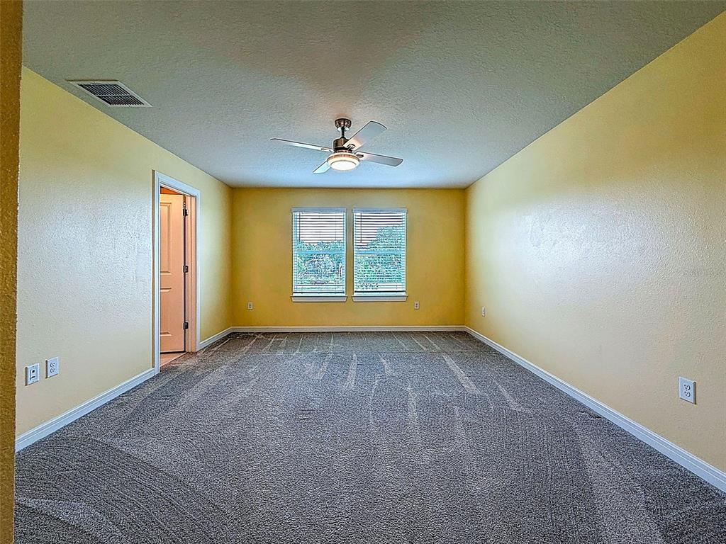 9324 Rally Spring Loop Wesley Chapel, FL 33545 - Photo 28 of 57 a view of an empty room with a window
