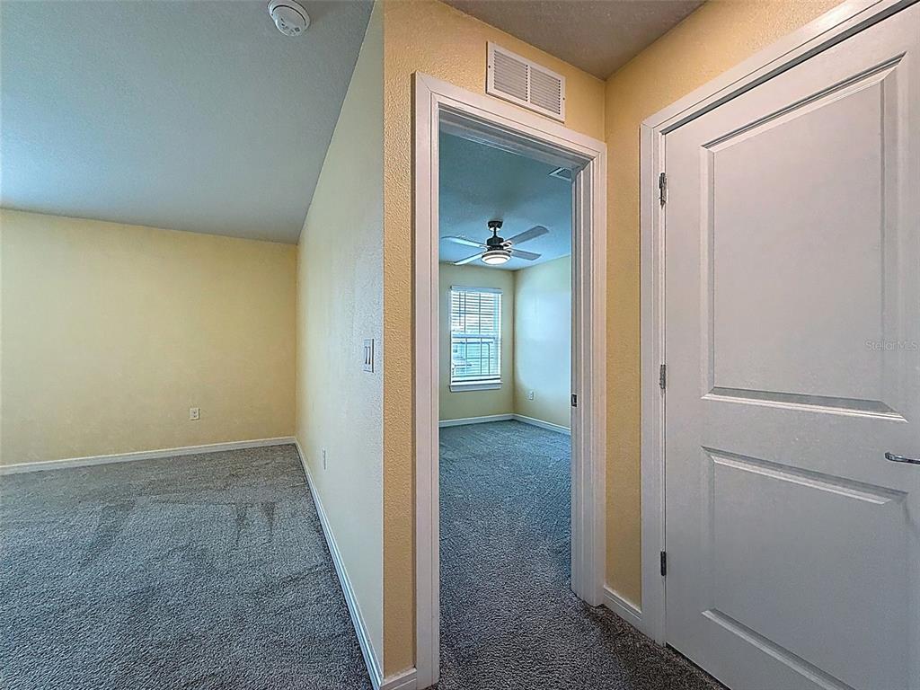 9324 Rally Spring Loop Wesley Chapel, FL 33545 - Photo 34 of 57 a view of a bathroom from a hallway