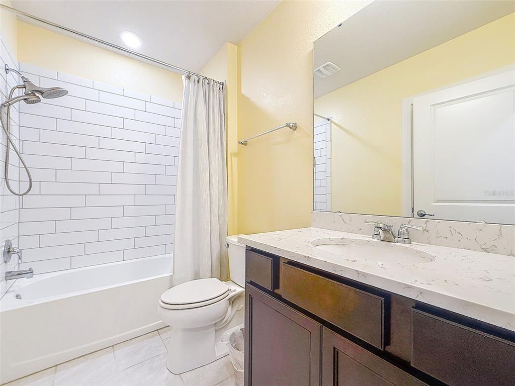9324 Rally Spring Loop Wesley Chapel, FL 33545 - Photo 36 of 57 a bathroom with a sink a toilet and shower