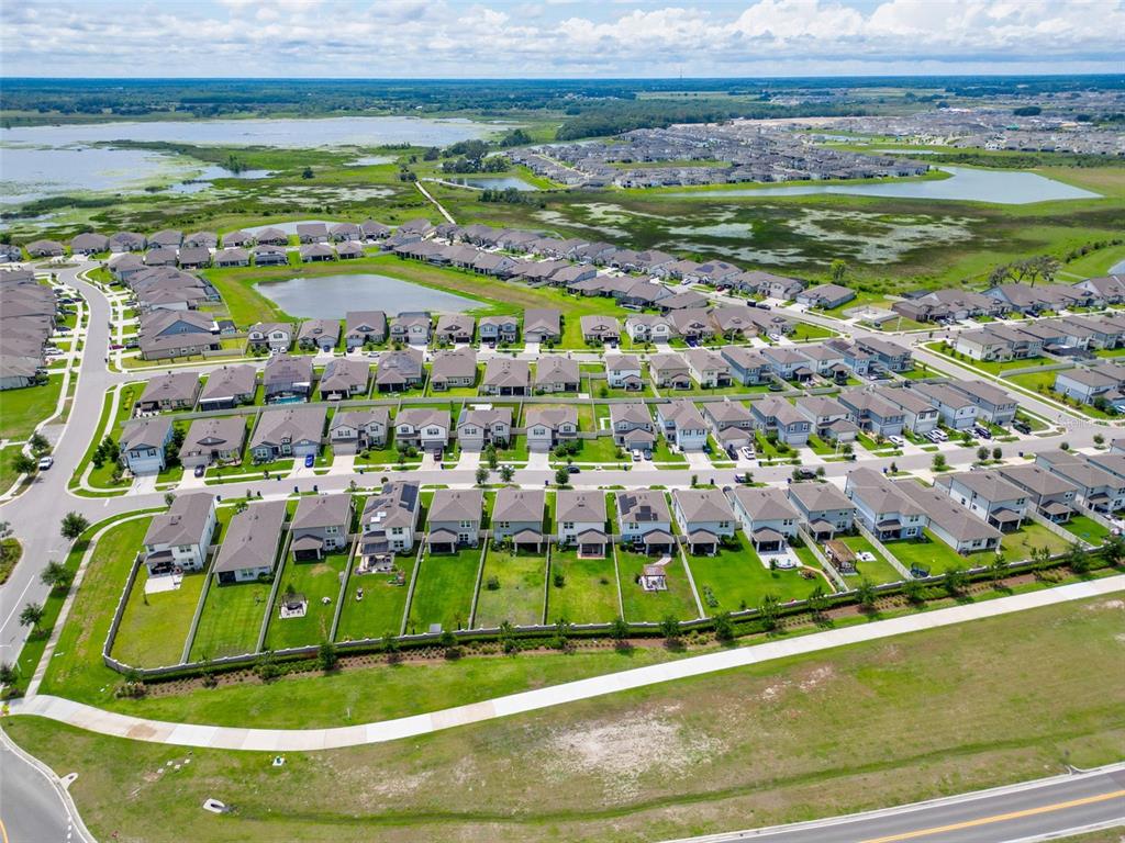 9324 Rally Spring Loop Wesley Chapel, FL 33545 - Photo 52 of 57 a view of a swimming pool with a yard