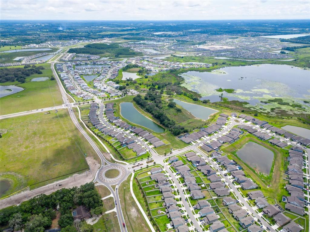 9324 Rally Spring Loop Wesley Chapel, FL 33545 - Photo 54 of 57 an aerial view of residential houses with outdoor space