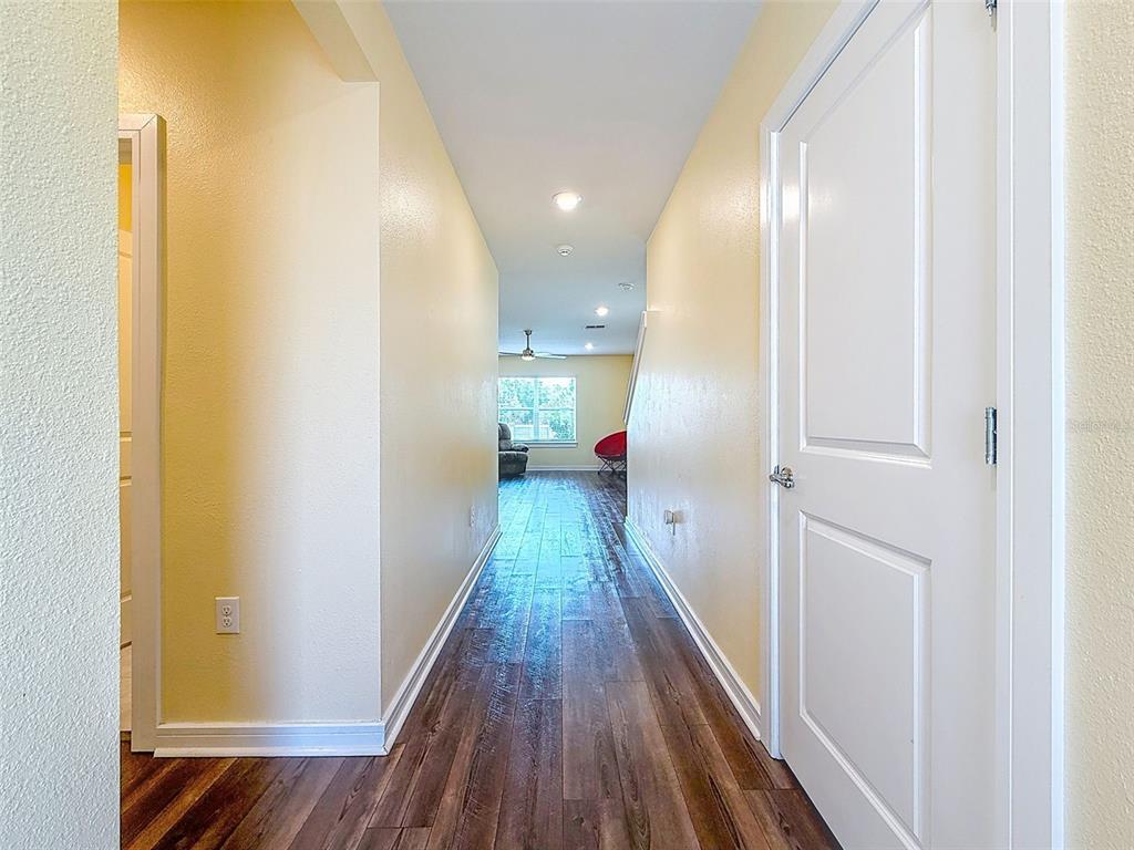 9324 Rally Spring Loop Wesley Chapel, FL 33545 - Photo 9 of 57 a view of hallway with wooden floor