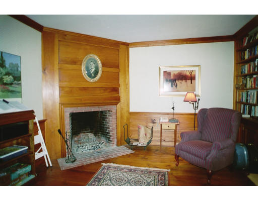 409 Pepperell Road Groton, MA 01450 - Photo 11 of 28 a living room with furniture a flat screen tv and a fireplace