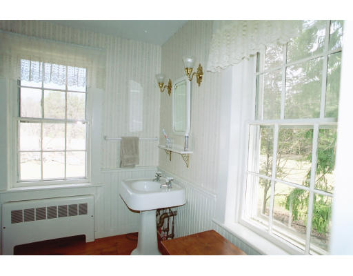 409 Pepperell Road Groton, MA 01450 - Photo 20 of 28 a bathroom with a sink a mirror and a shower