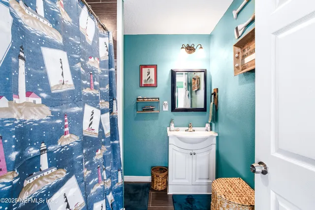 a bathroom with a sink mirror and toilet