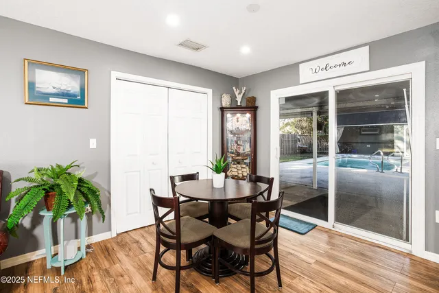a view of a dining room with furniture and a potted plant