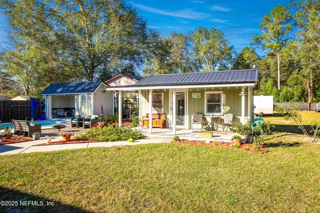a front view of a house with swimming pool and sitting area