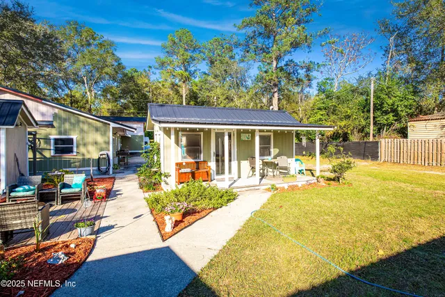a view of a house with swimming pool and sitting area