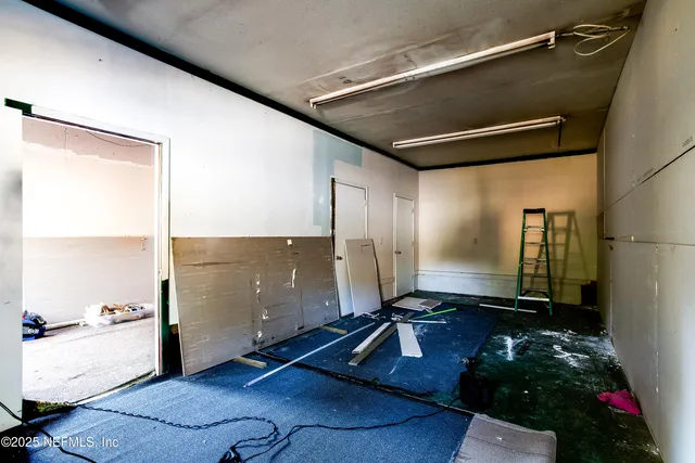 a bathroom with a mirror and shower