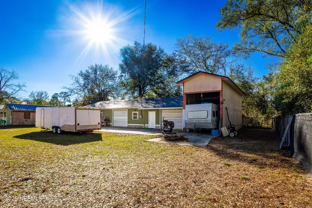 a view of a house with pool and sitting area