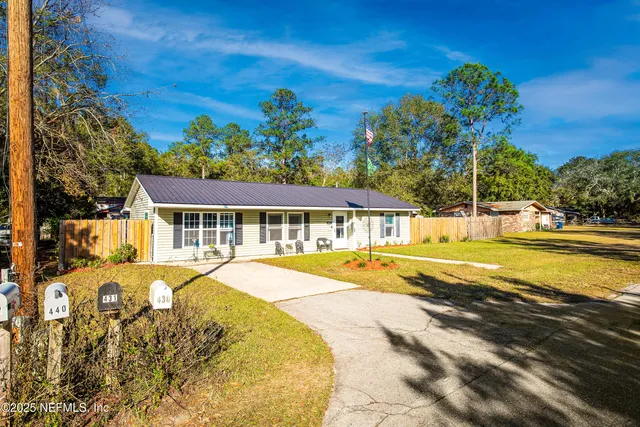a view of a house with pool and sitting area