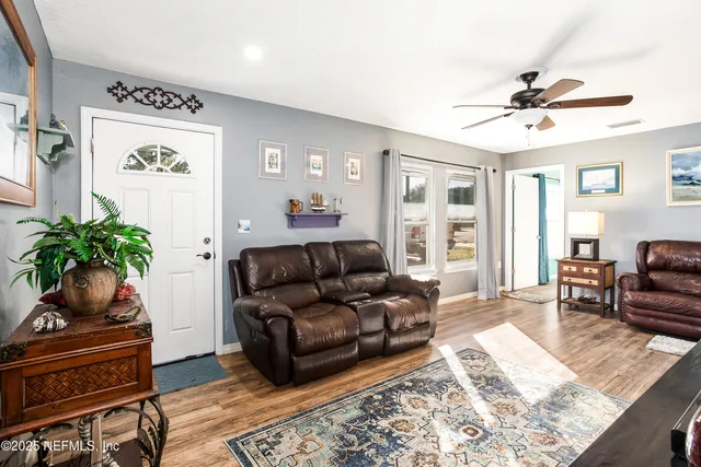 a living room with furniture and wooden floor