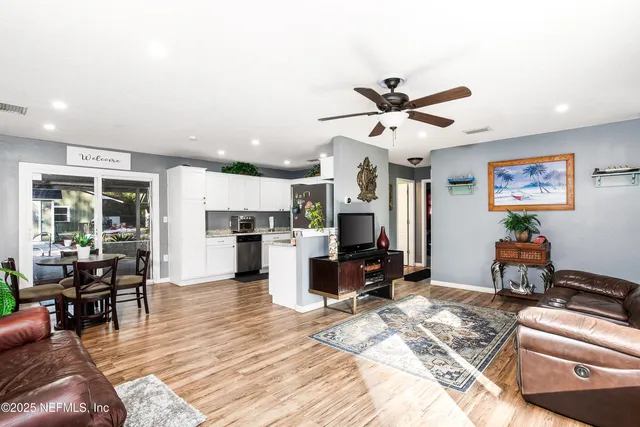 a living room with furniture and kitchen view