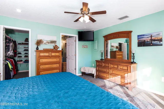 a bedroom with furniture and a dresser