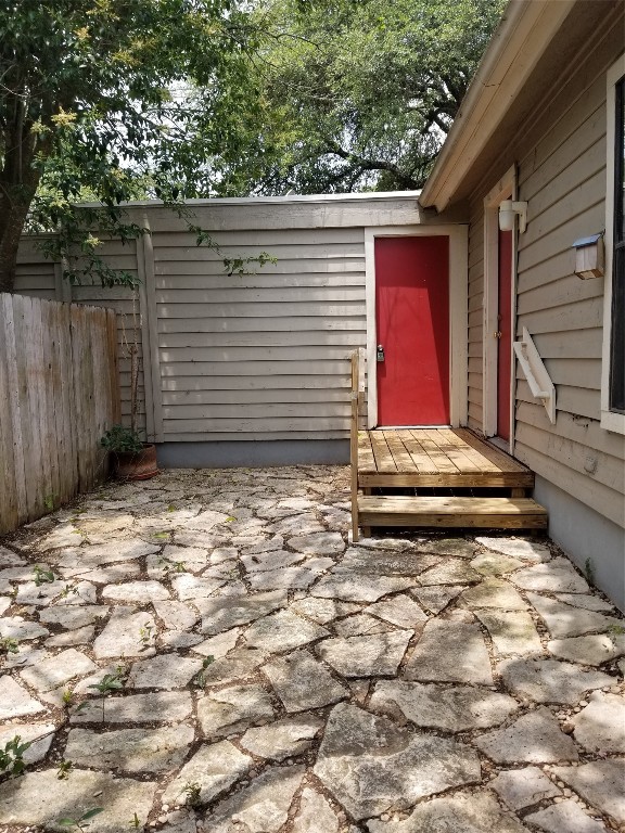a view of house with backyard and wooden fence