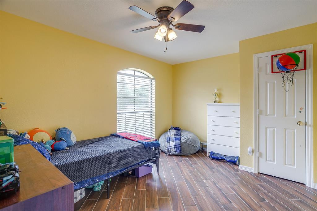 1050 Hampel Road Palmer, TX 75152 - Photo 29 of 35 a bedroom with a bed and wooden floor