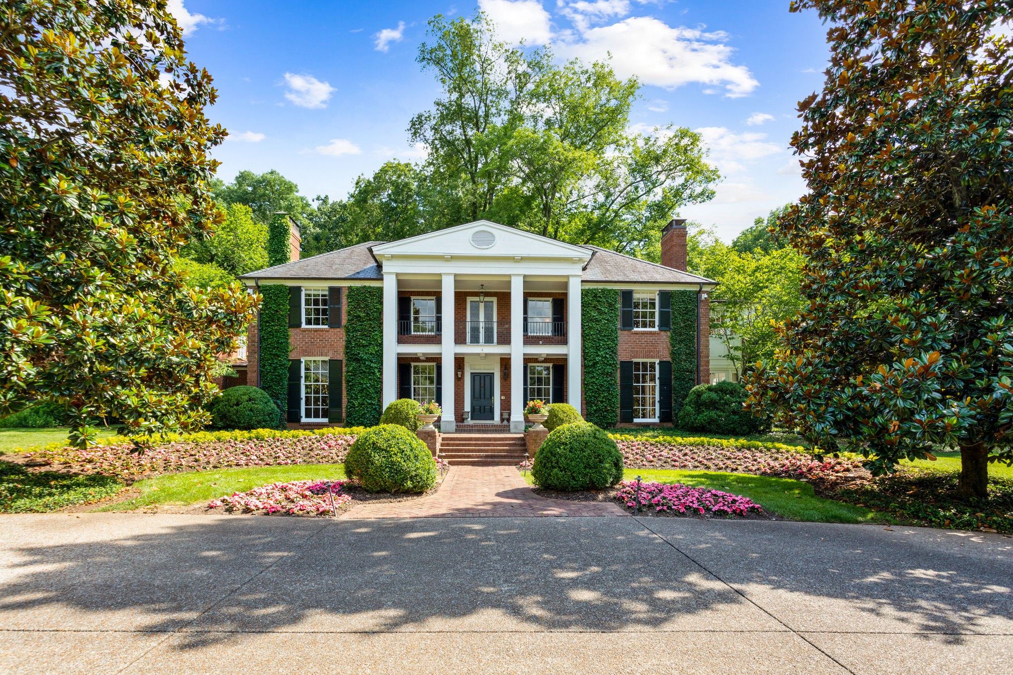 907 Overton Lea Road Nashville, TN 37220 - Photo 2 of 24 a front view of a house with a yard