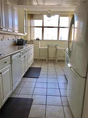 a bathroom with a granite countertop toilet sink and mirror