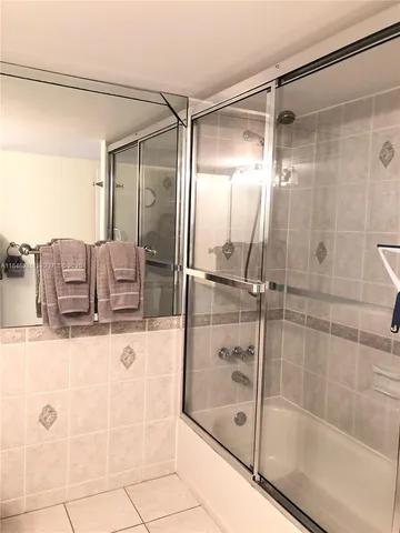 a living room with a flat screen tv and a rug