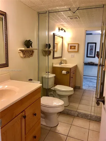 a bathroom with a glass shower door