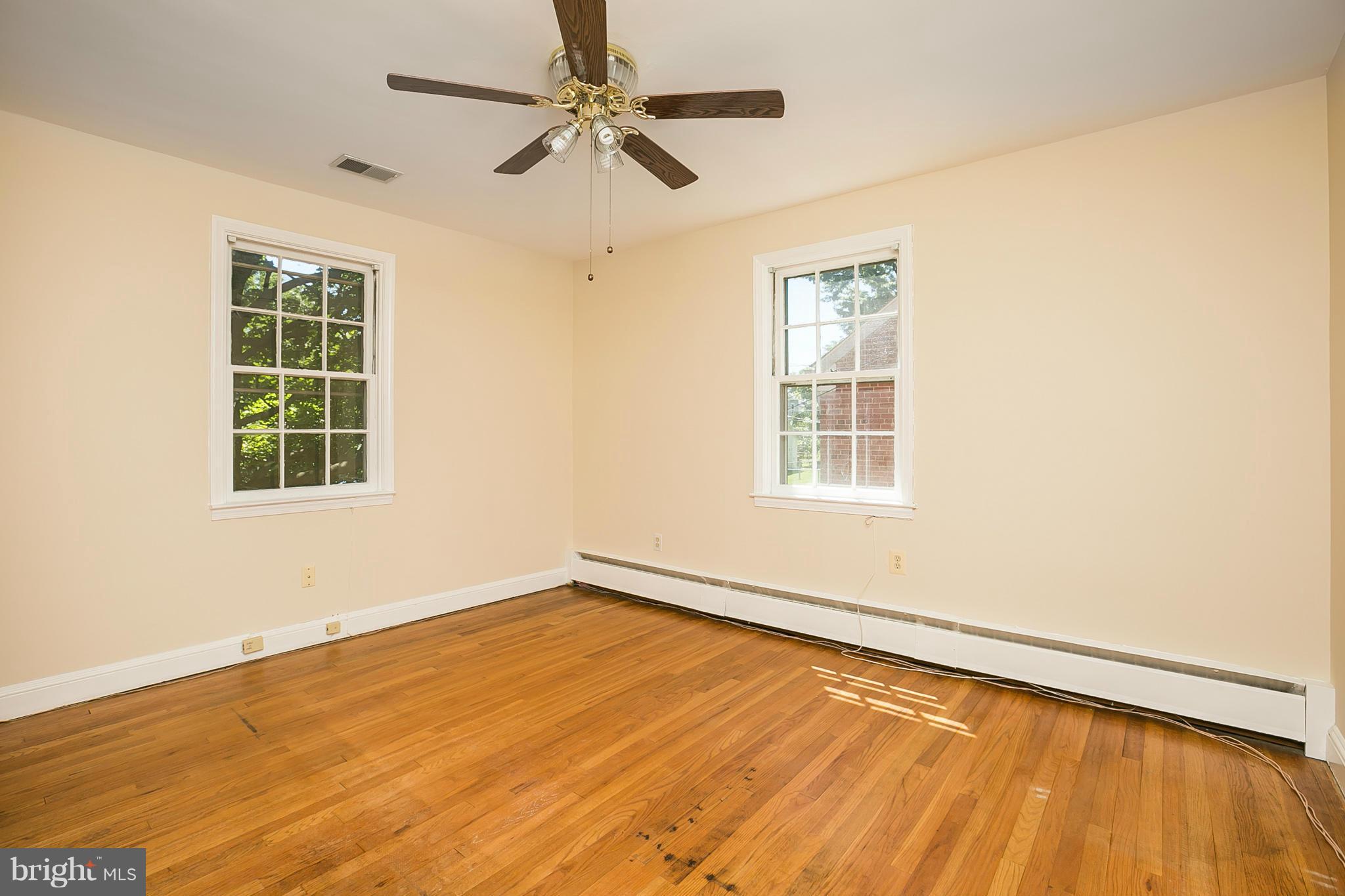 3301 Marnat Road Baltimore, MD 21208 - Photo 12 of 27 a view of an empty room with wooden floor and a window