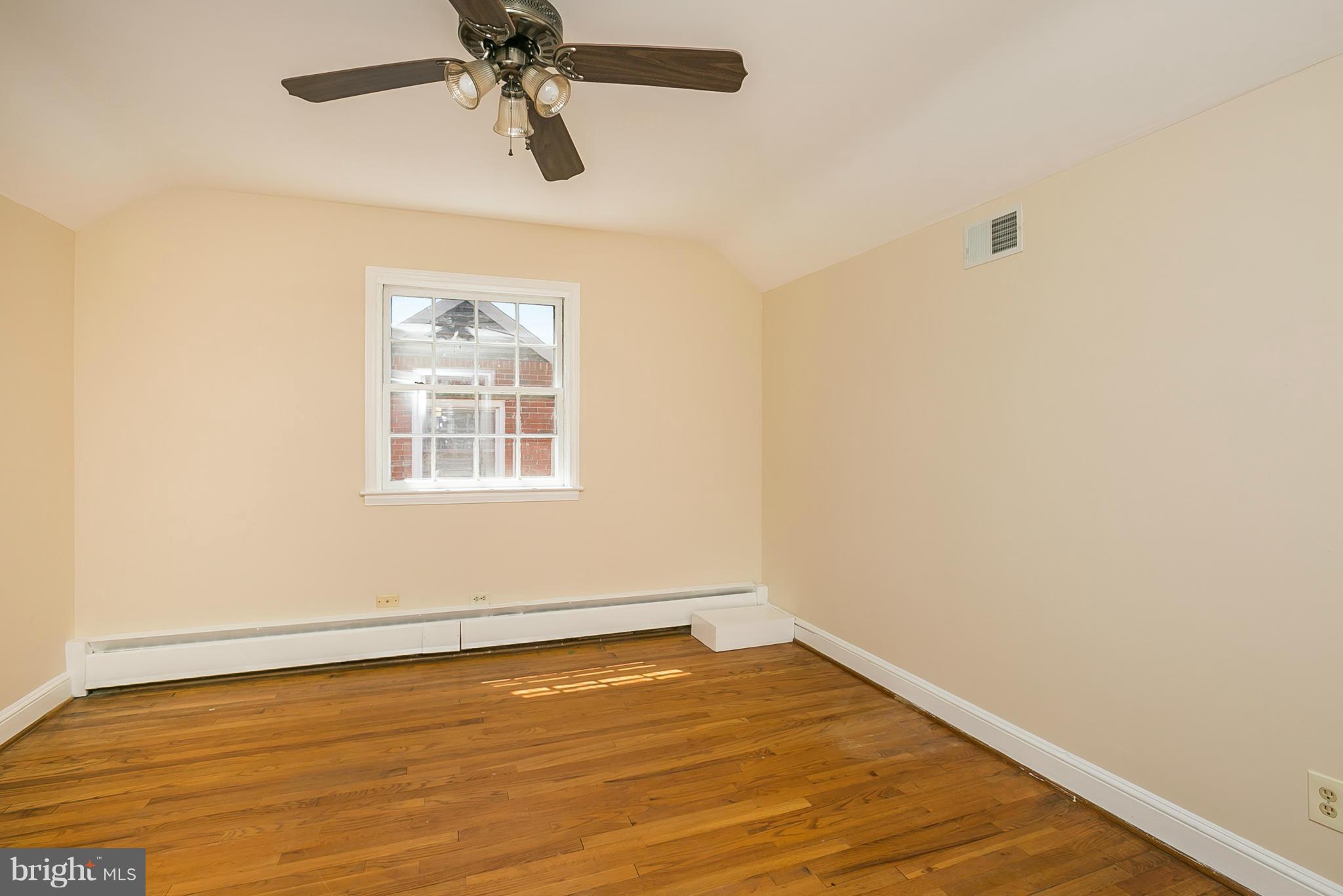 3301 Marnat Road Baltimore, MD 21208 - Photo 15 of 27 wooden floor in an empty room with a window