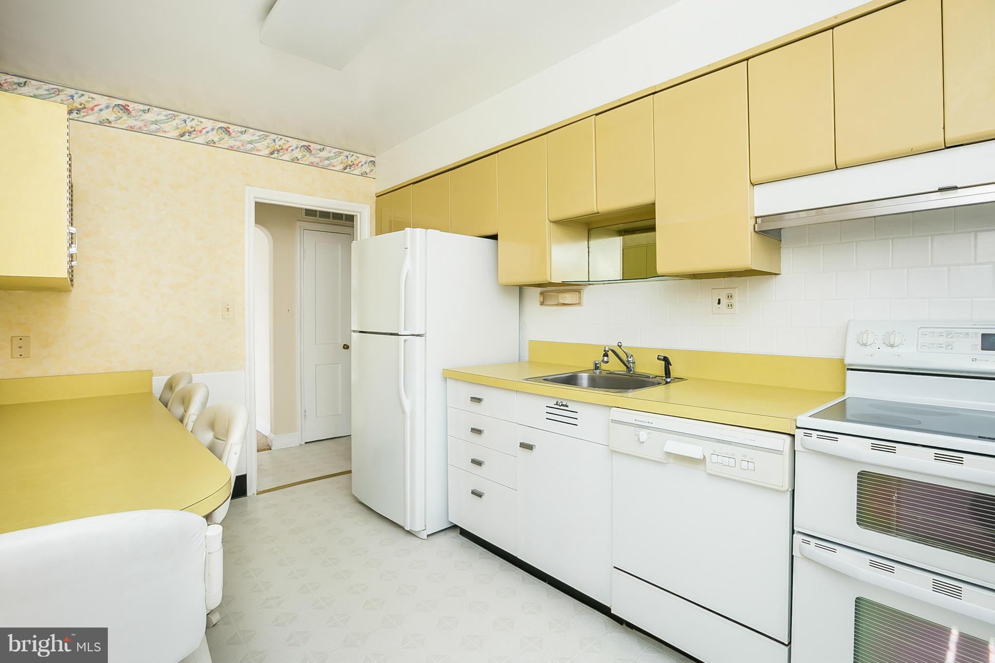 3301 Marnat Road Baltimore, MD 21208 - Photo 7 of 27 a kitchen with a refrigerator and a sink