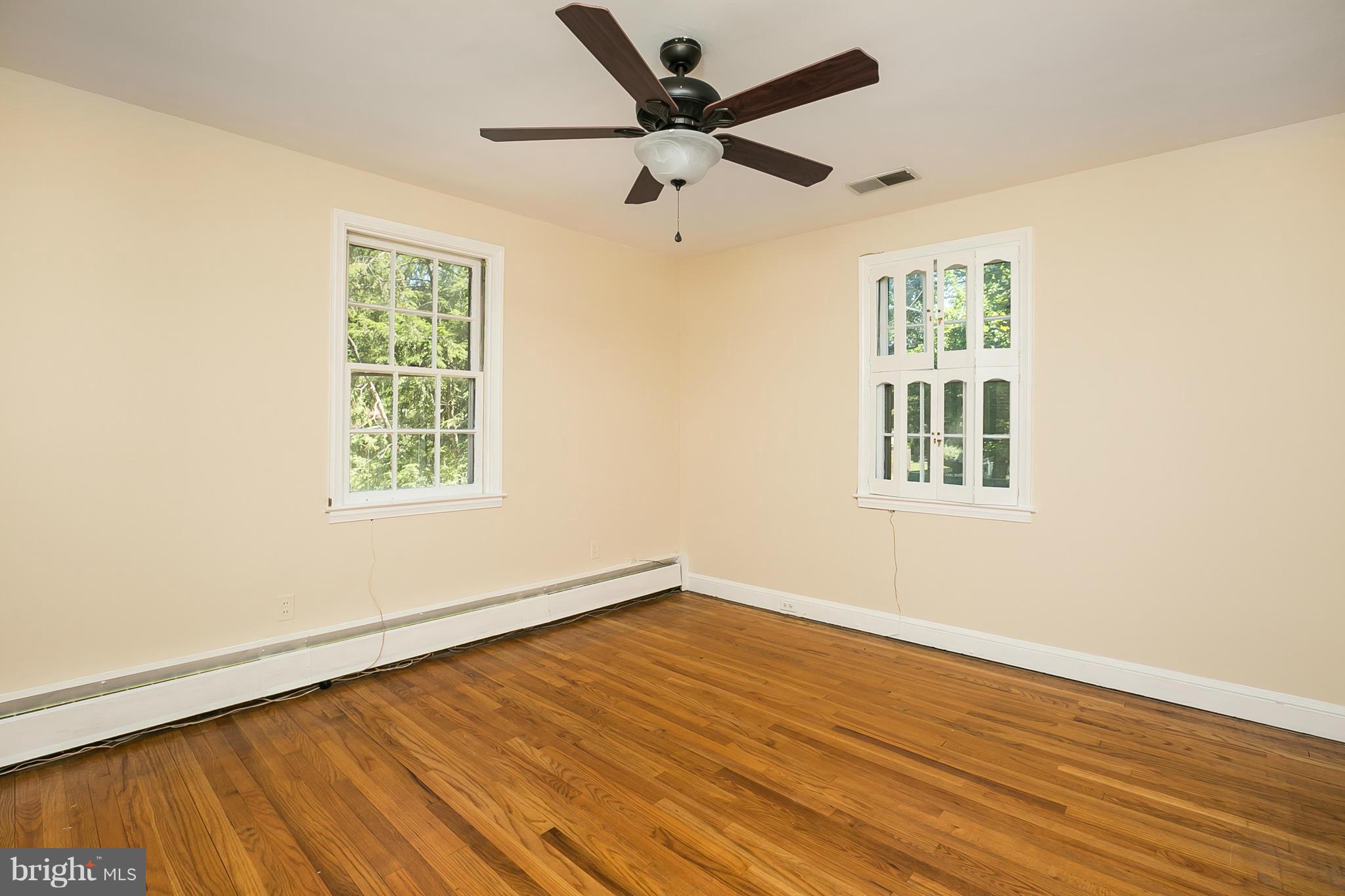3301 Marnat Road Baltimore, MD 21208 - Photo 9 of 27 a view of an empty room with wooden floor and a window