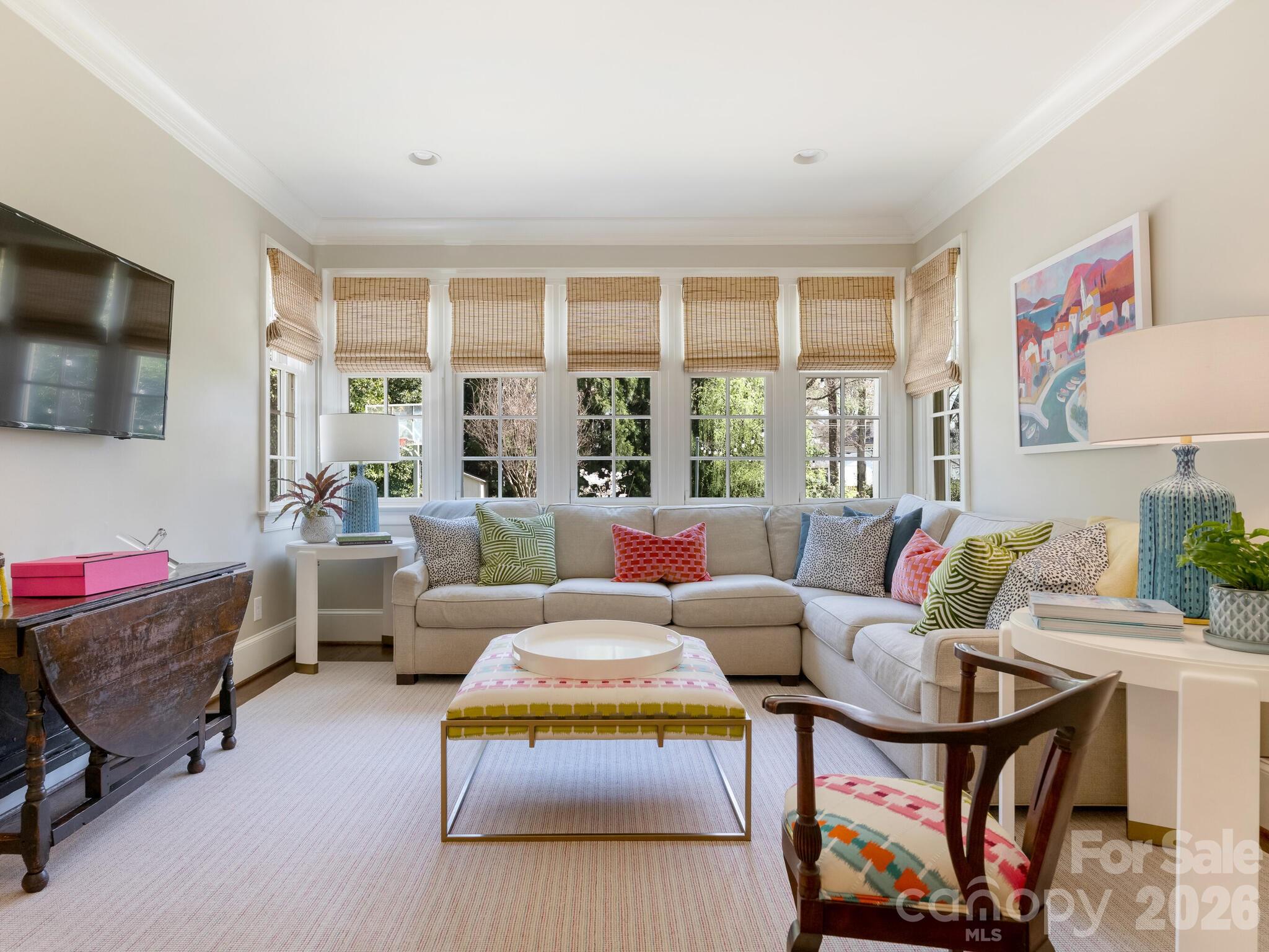 1413 Andover Road Charlotte, NC 28211 - Photo 18 of 41 a living room with furniture a flat screen tv and a floor to ceiling window