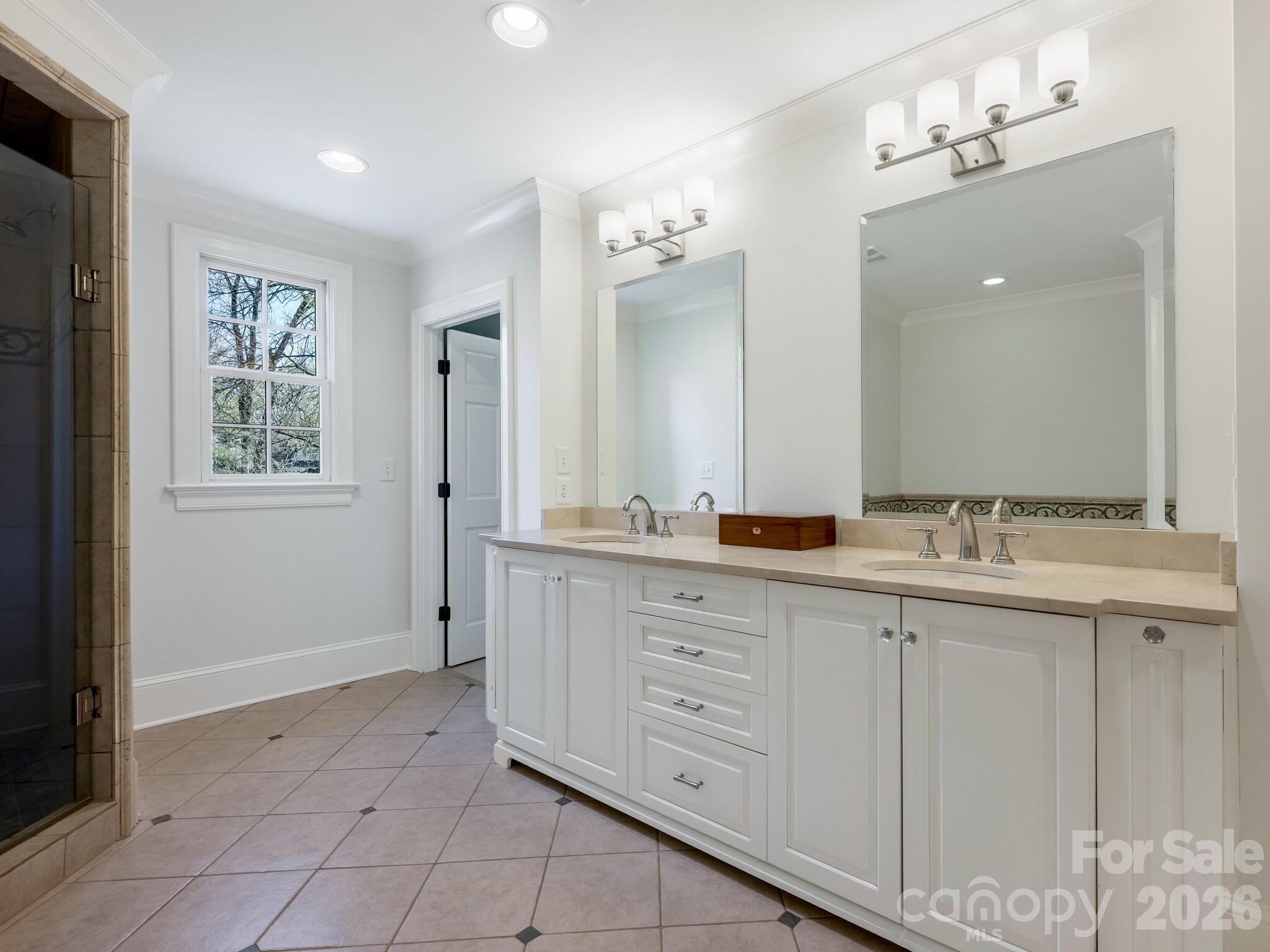 1413 Andover Road Charlotte, NC 28211 - Photo 25 of 41 a spacious bathroom with a granite countertop sink and a mirror