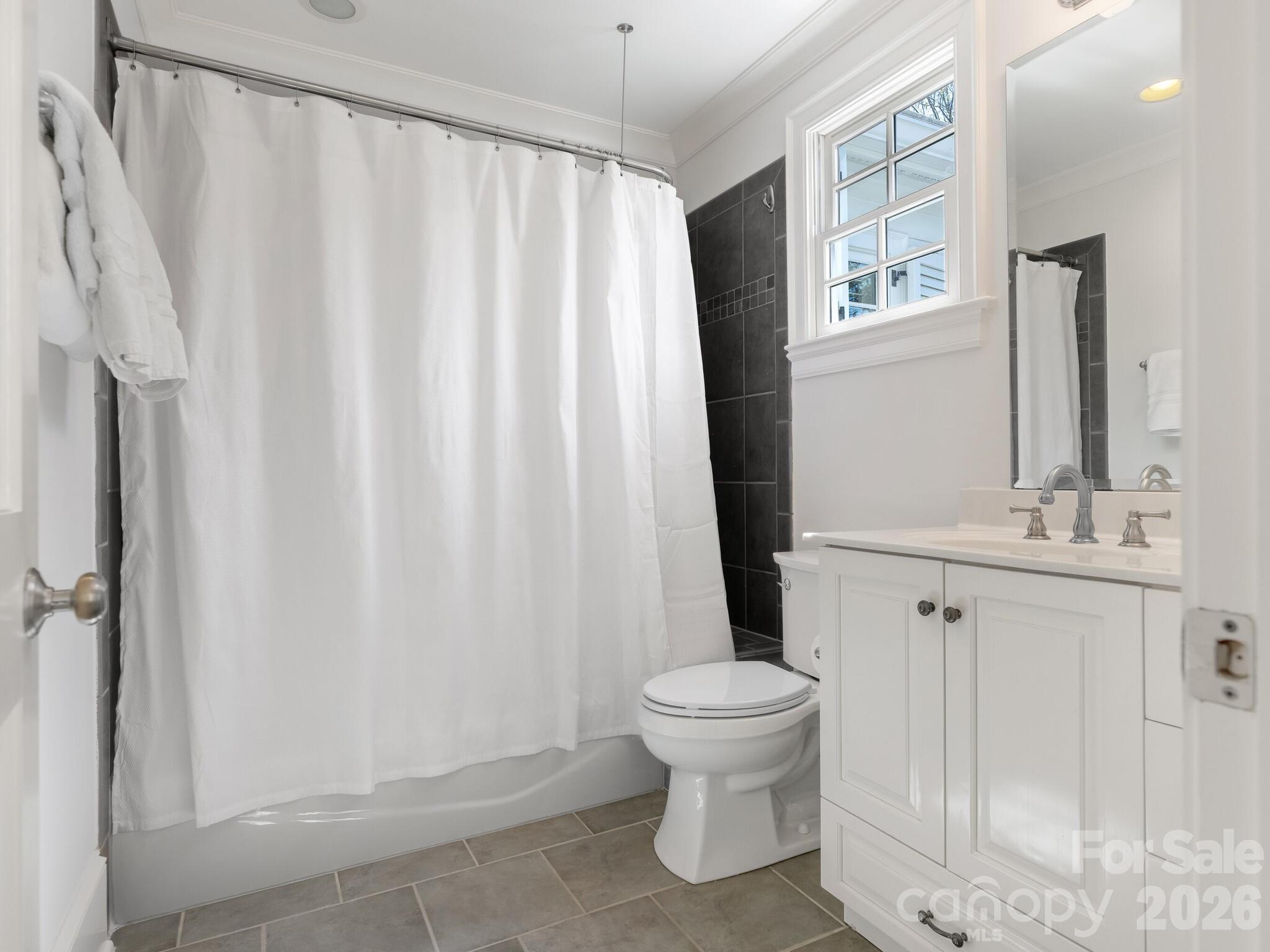 1413 Andover Road Charlotte, NC 28211 - Photo 32 of 41 a bathroom with a sink a toilet a window and shower