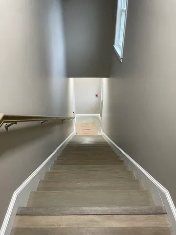 a view of yard with a car parked on the road