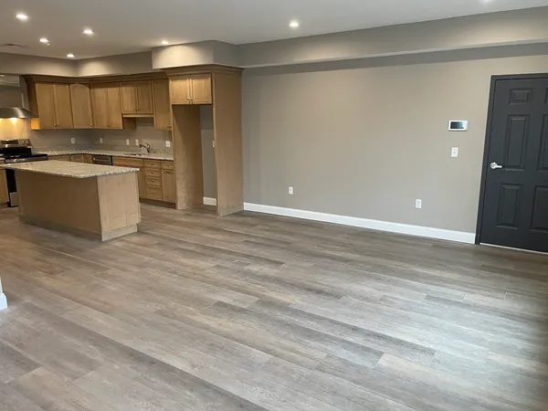 a large kitchen with stainless steel appliances granite countertop a stove and a refrigerator