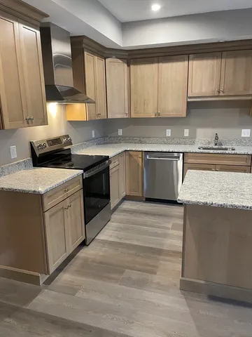 a kitchen with a stove top oven sink and cabinets
