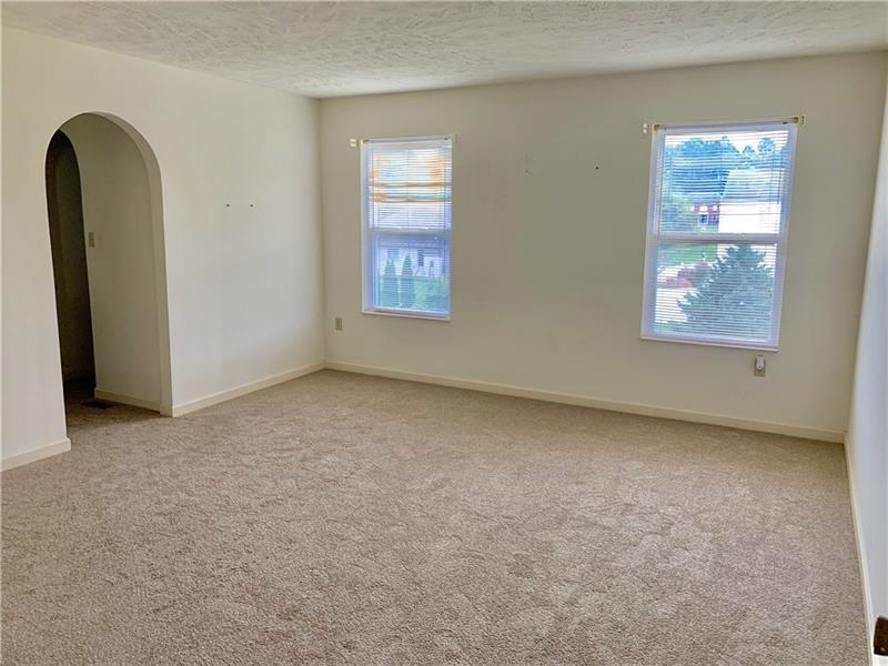 43 Peters Road Greensburg, PA 15601 - Photo 14 of 25 A LARGE UPSTAIRS BEDROOM WITH WALK IN CLOSET AND PRIVATE VANITY FOR PREPPING FOR THE DAY. TWO WINDOWS TO PROVIDE LOTS OF NATURAL LIGHT IN THIS NEUTRALLY PAINTED ROOM WITH NEW FLOORING
