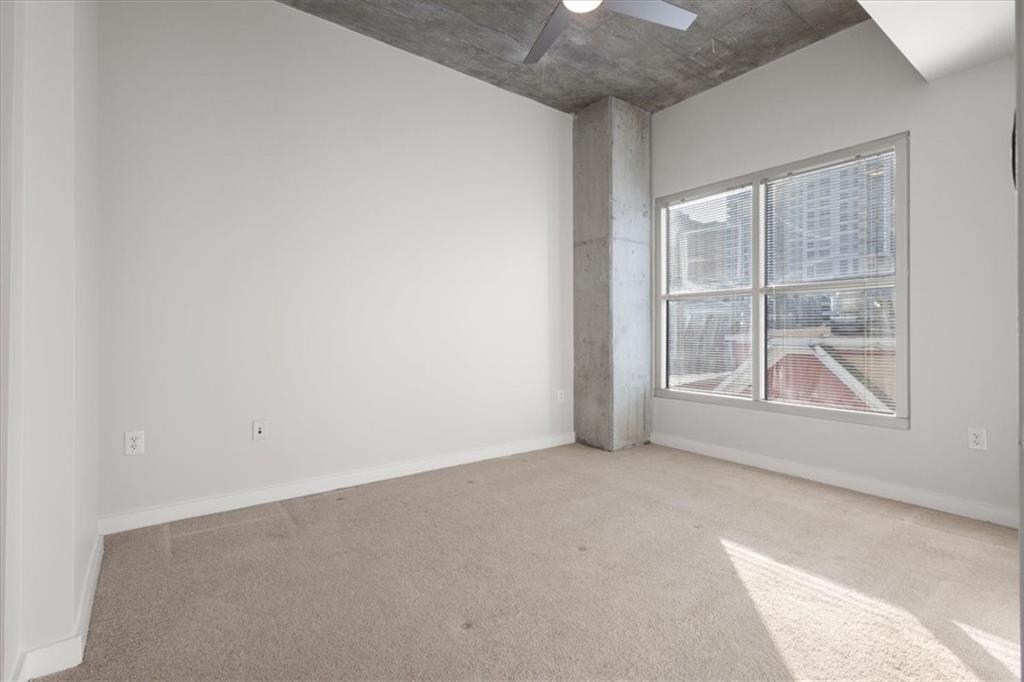 250 Pharr Road Northeast, Unit 309 Atlanta, GA 30305 - Photo 14 of 37 an empty room with windows