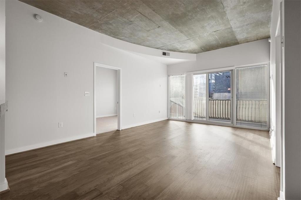 250 Pharr Road Northeast, Unit 309 Atlanta, GA 30305 - Photo 2 of 37 a view of an empty room with wooden floor