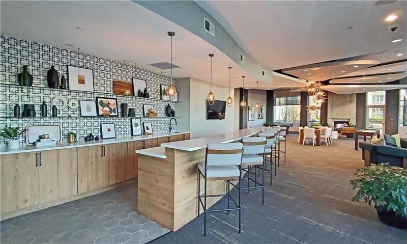 250 Pharr Road Northeast, Unit 309 Atlanta, GA 30305 - Photo 33 of 37 a large living room with stainless steel appliances kitchen island granite countertop furniture and a kitchen view