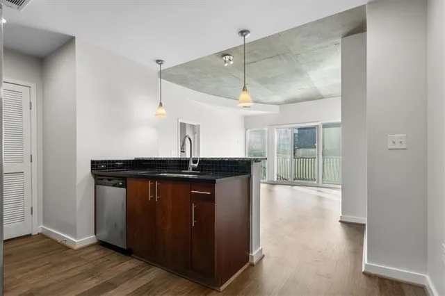 a kitchen with stainless steel appliances granite countertop a sink and wooden cabinets
