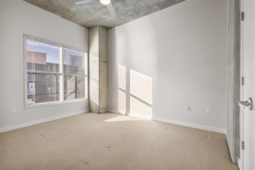 250 Pharr Road Northeast, Unit 309 Atlanta, GA 30305 - Photo 9 of 37 an empty room with a empty space and windows