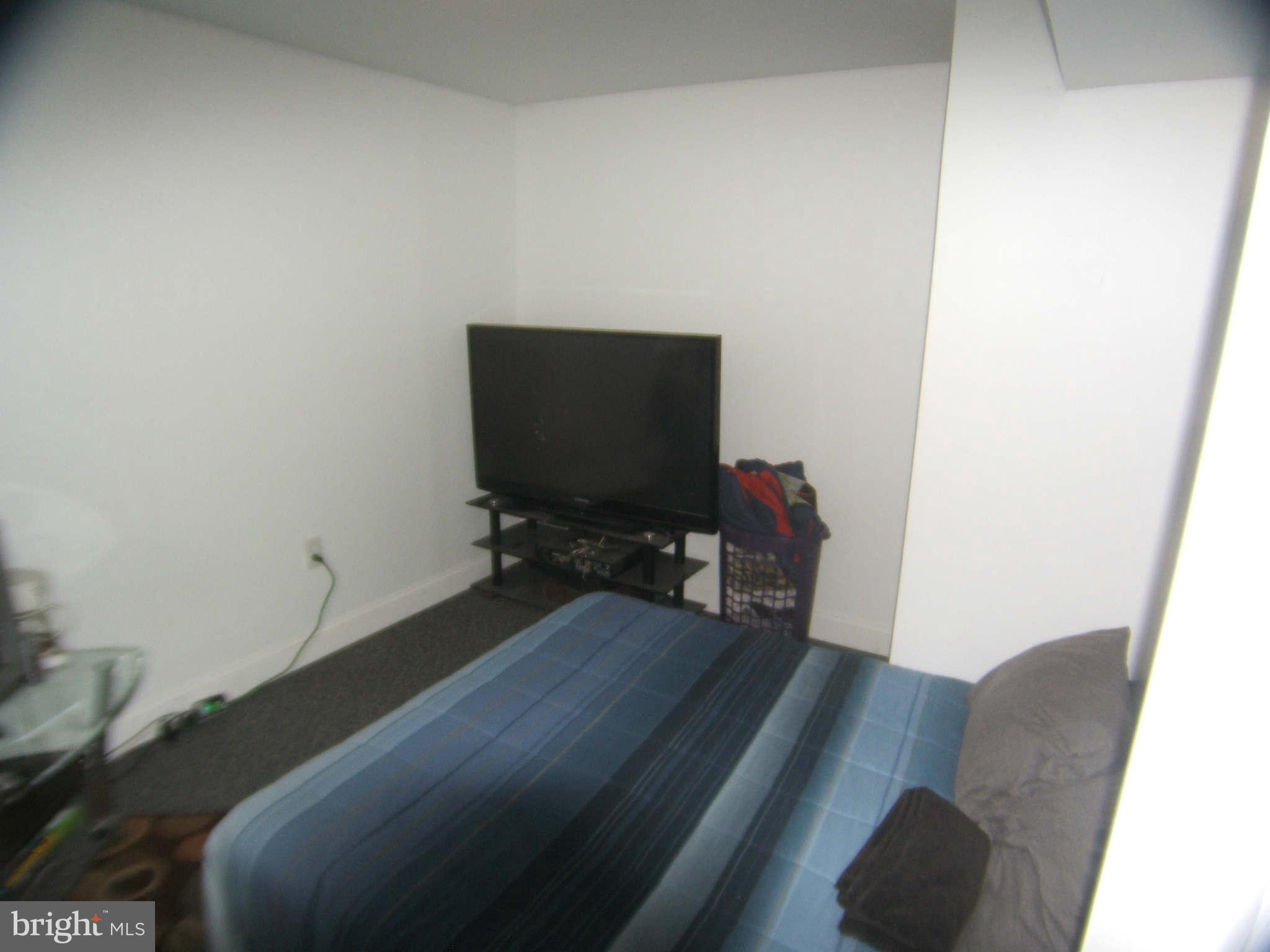 19113 Staleybridge Road Germantown, MD 20876 - Photo 16 of 17 a bedroom with a bed and a chair