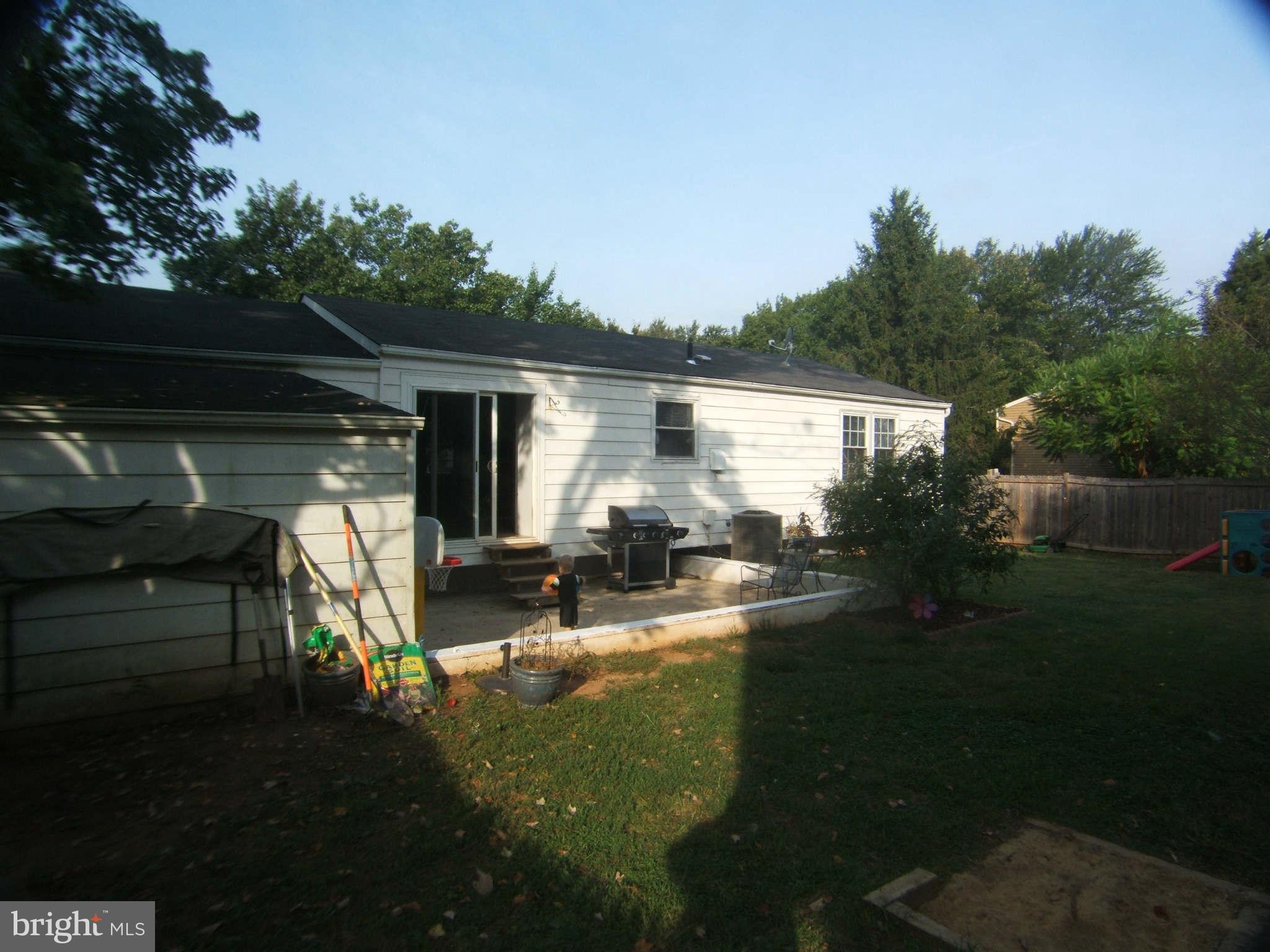 19113 Staleybridge Road Germantown, MD 20876 - Photo 17 of 17 a view of house with backyard outdoor seating and hardwood