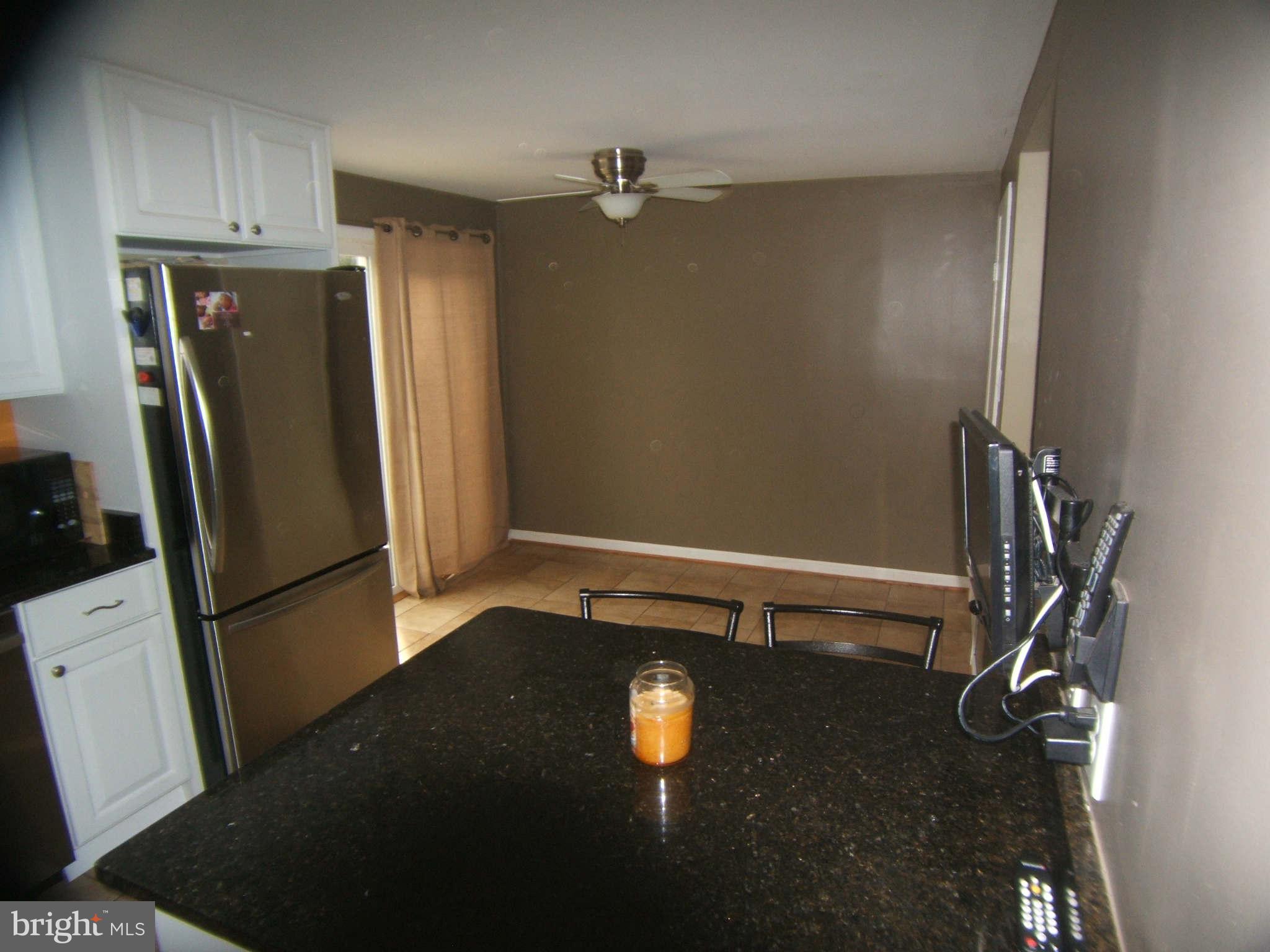 19113 Staleybridge Road Germantown, MD 20876 - Photo 10 of 17 a view of a storage & utility room with a refrigerator
