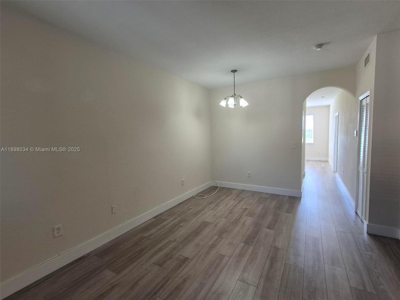 17820 Northwest 73rd Avenue, Unit 2011 Hialeah, FL 33015 - Photo 2 of 16 a view of empty room with wooden floor