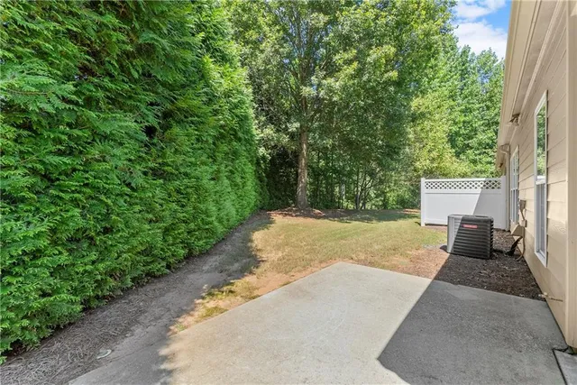 a view of a backyard with a garden and trees