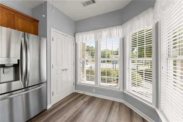 a kitchen with stainless steel appliances a refrigerator and a window