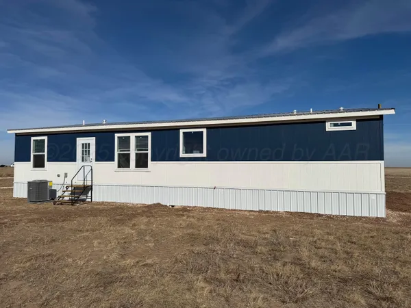 a view of house with a yard